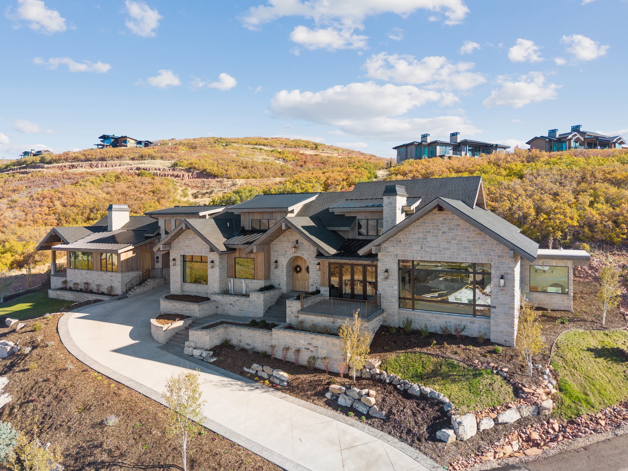 Wide exterior photograph of a custom mountain home in Golden Eagle, Hideout, Utah.