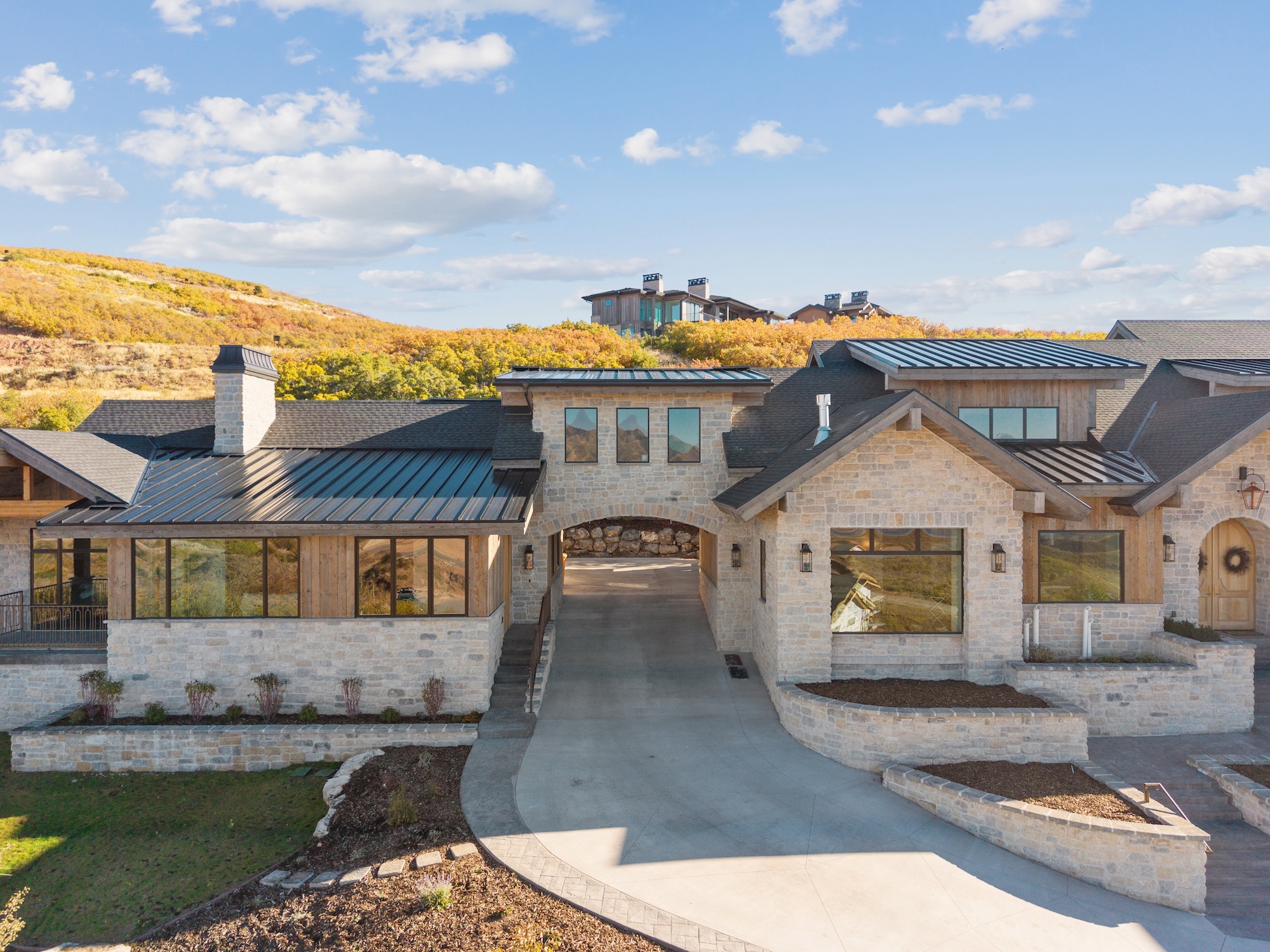 Exterior photograph showing the driveway and front entry of a custom home in Golden Eagle, Hideout, Utah.