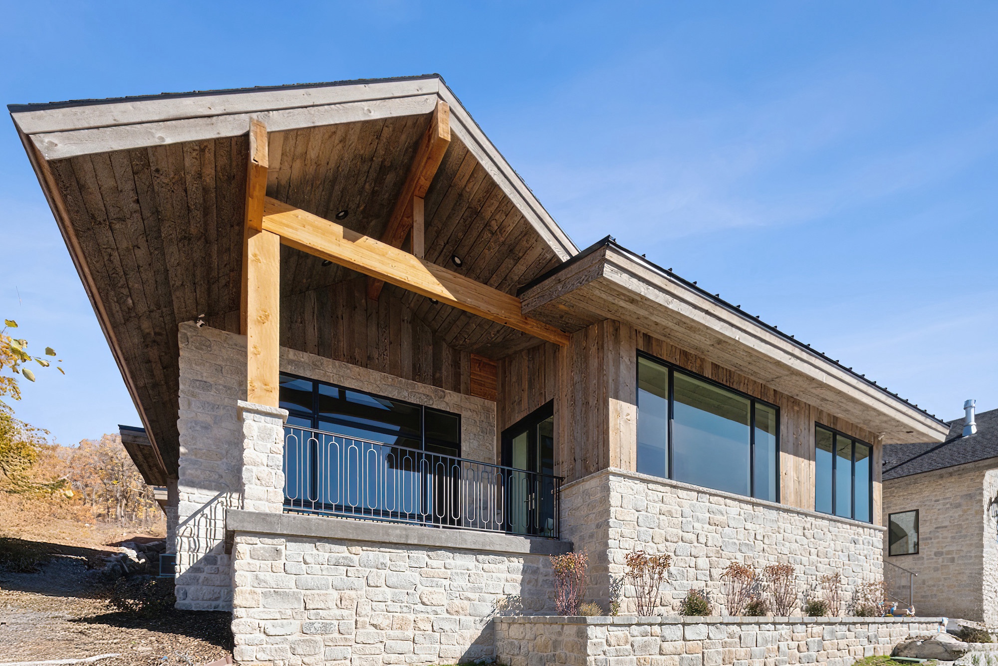 Exterior photograph of covered outdoor living space on a custom home in Golden Eagle, Hideout, Utah.